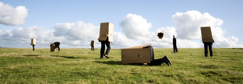 image of people in boxes in field